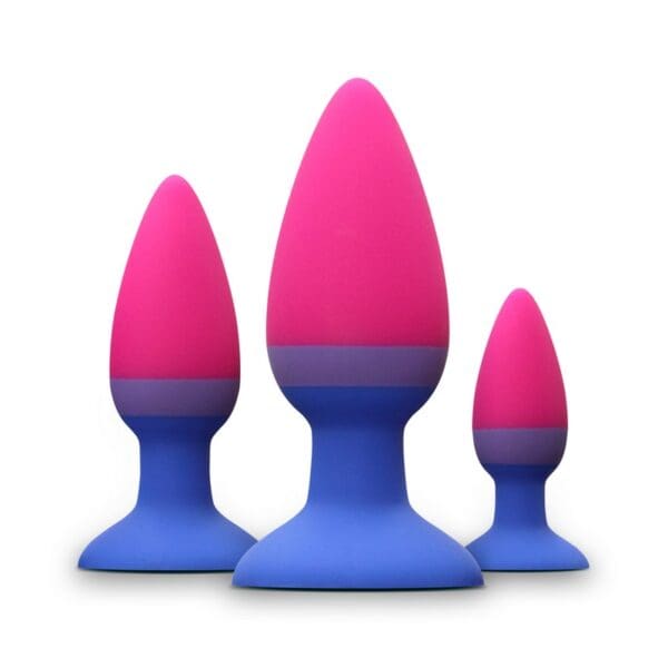 Three pink and blue silicone butt plugs.