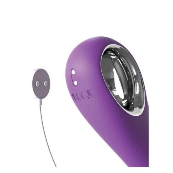 A purple vibrator next to a button.