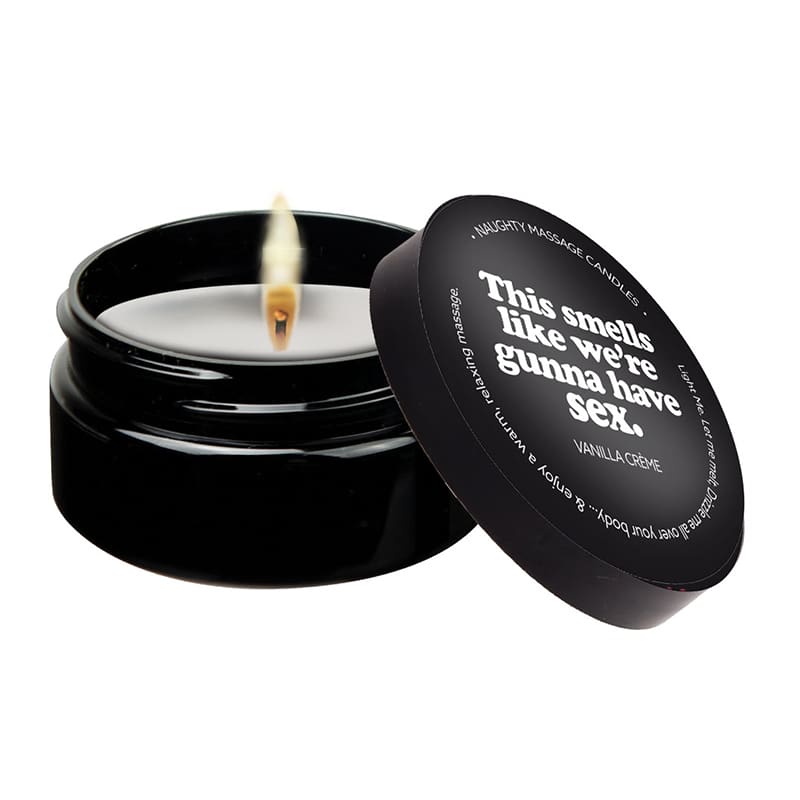 A candle that is sitting in a black container.