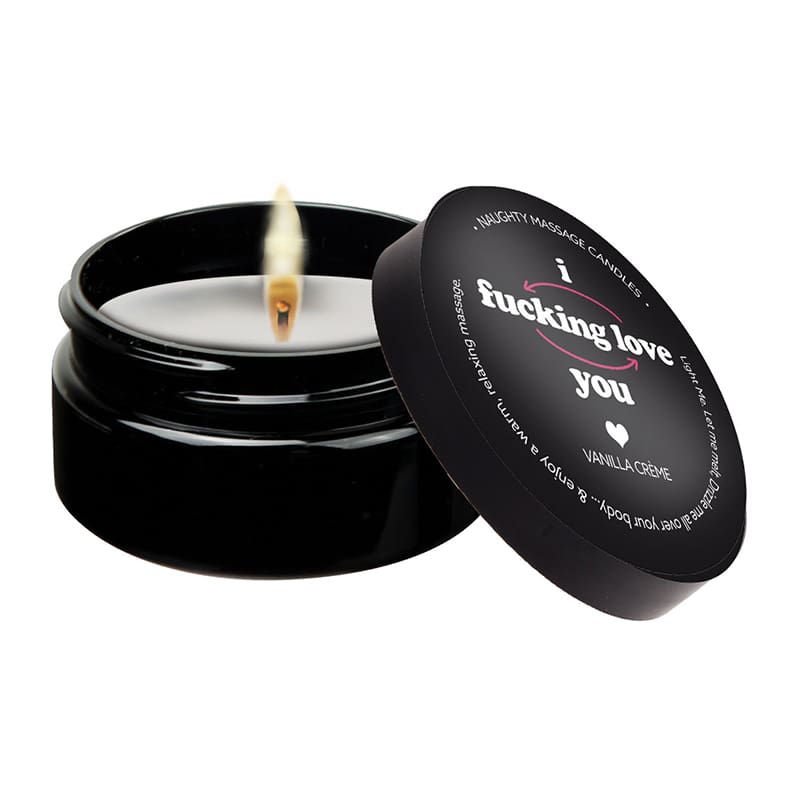 A candle in a black container with the lid open.