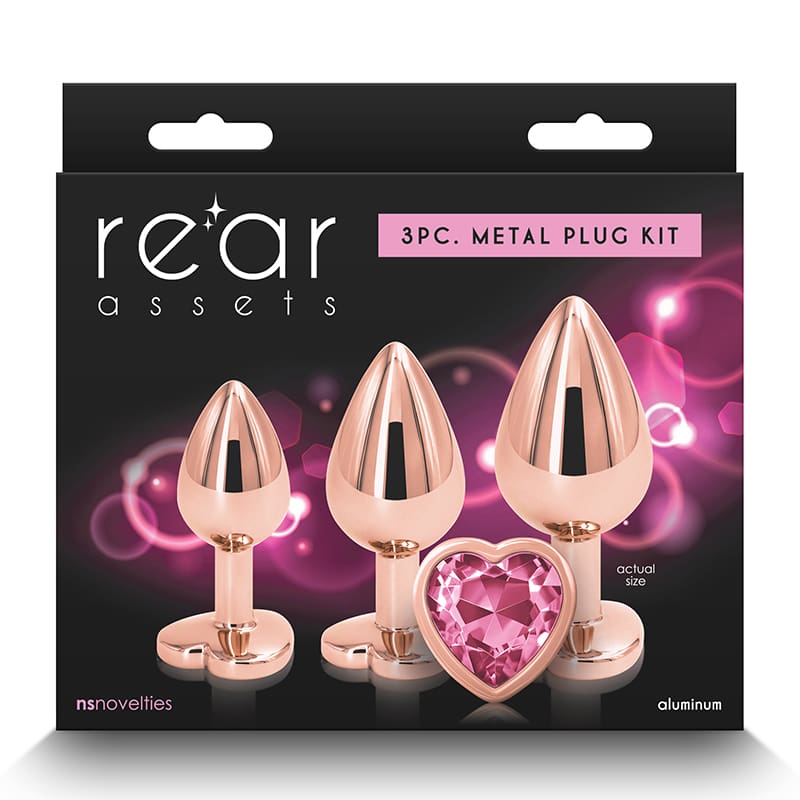 A set of three metal plugs with pink jewels.