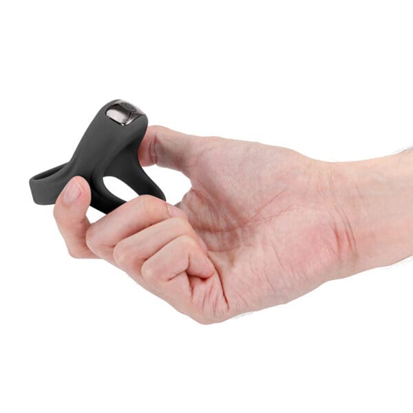 A person holding a small black object in their hand.