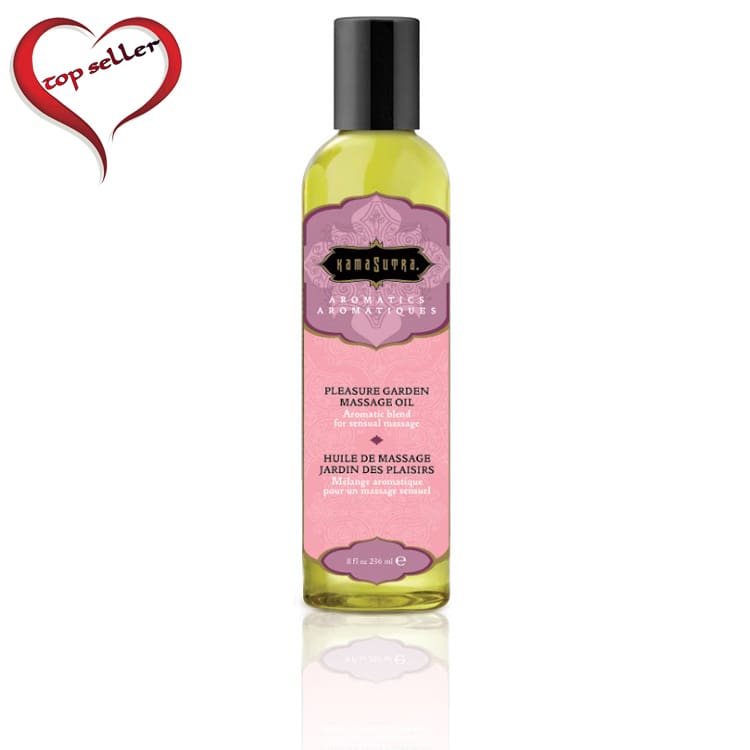 A bottle of massage oil with pink flowers.