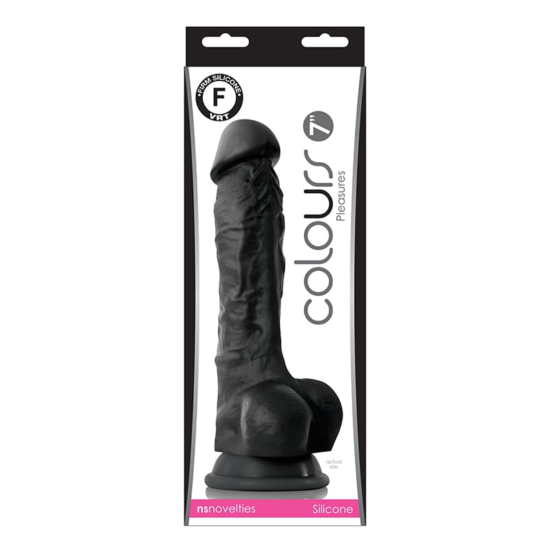 A black dildo in the package on top of a white table.