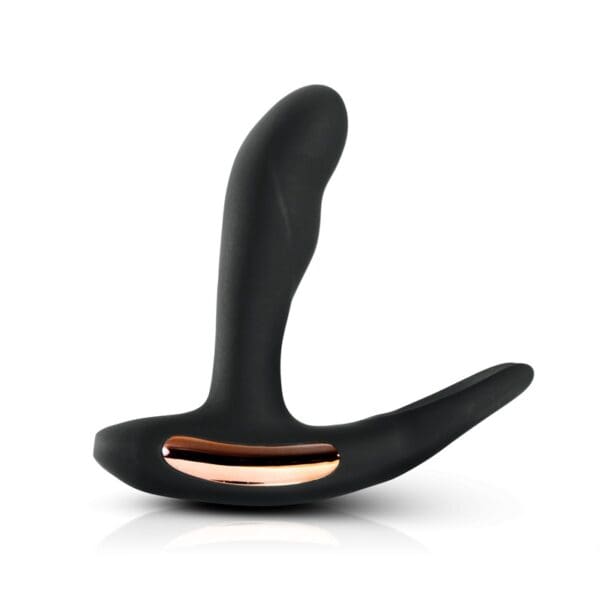 A black and gold dildo is sitting on top of the floor.
